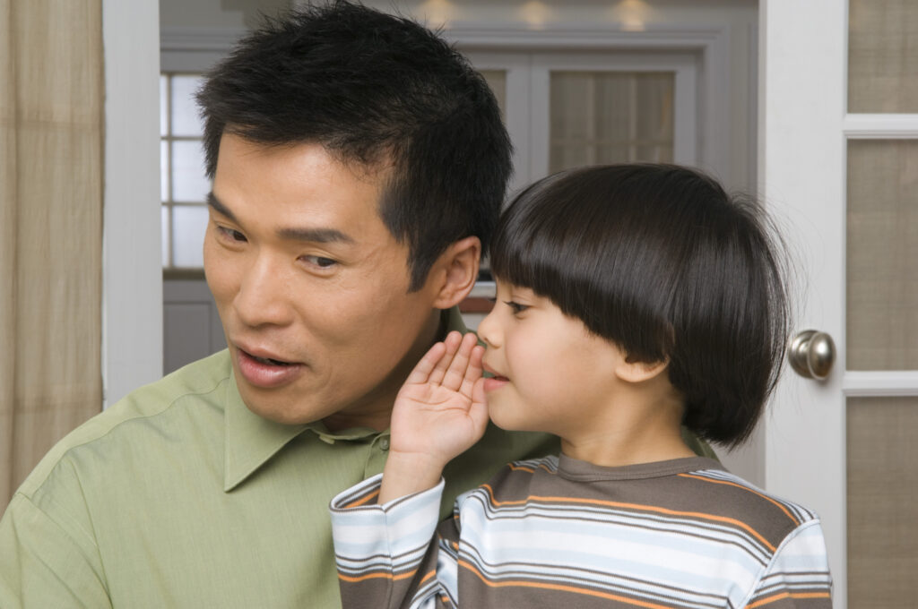 January's Guiding Principle: Listen First son whispering in fathers ear